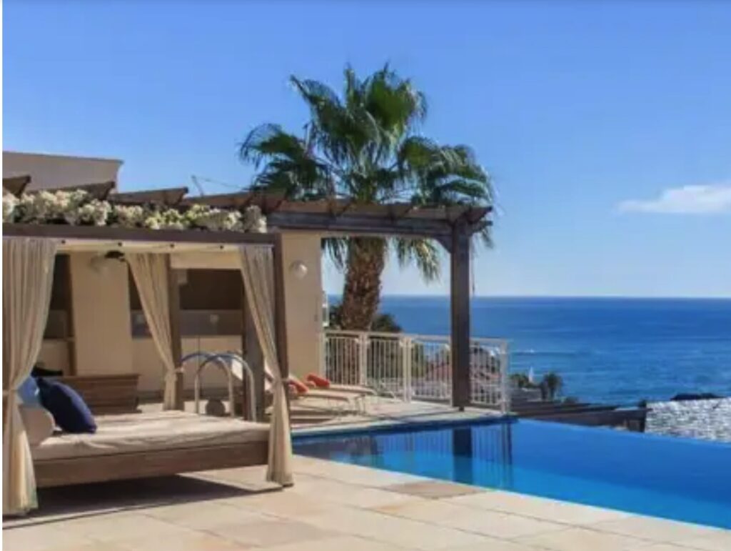 Decadent hotel in Cape Town, South Africa. Article in The Hotel Journal.
View out to see from a cabana overlooking a swimming pool.