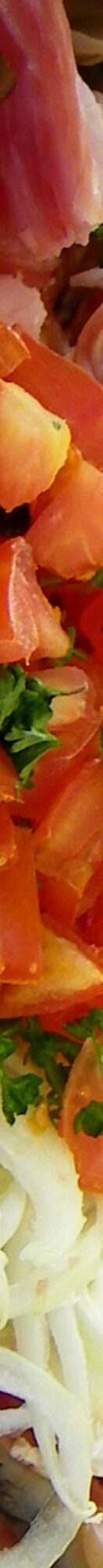 Slice of fresh tomatoes, onions, a long and thin snapshot of delicious produce.