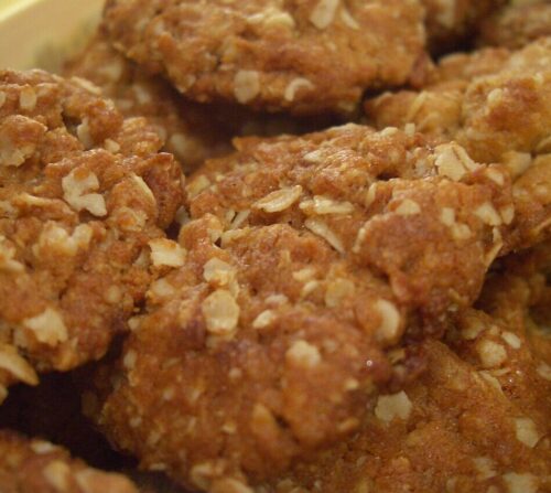 Golden ANZAC biscuits, never cookies, made with rolled oats, golden syrup, desiccated coconut and baking soda. These iconic biscuits have a rich national history and pride of place.
