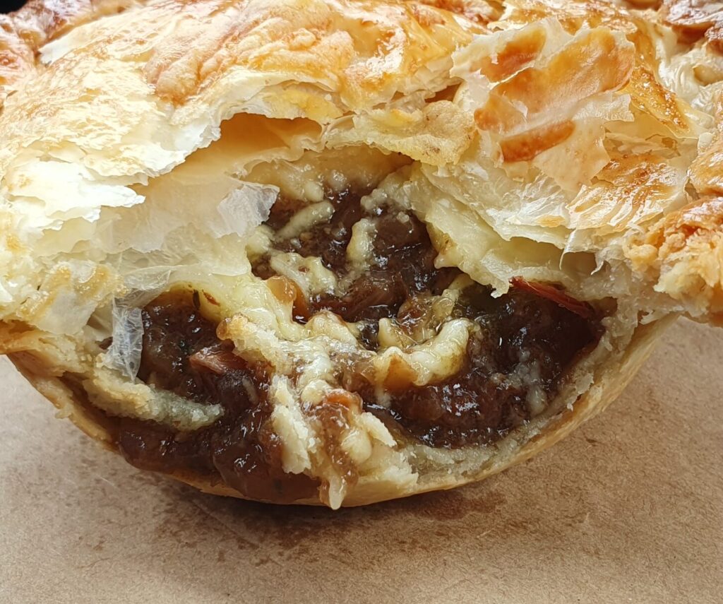 New Zealand's own famous pie, mince and cheese, this pie is a must-try if you're visiting. Golden flaky pastry surrounding mince beef filling and a healthy serving of grated cheddar that melts. Delish!