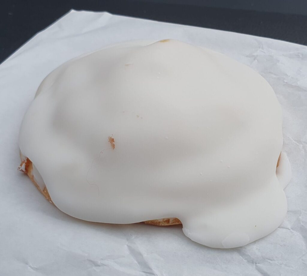 Apple teacake - a shortbread-like pastry casing around apple pie filling, coated in thick vanilla icing, it's perfect with your BigM drink after a surf!