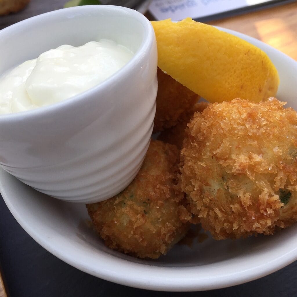 Picture of golden and crunchy seafood fritters, served with a creamy and tangy aioli dip. These croquettes were served at Auchrannie Hotel, on the island of Arran in Scotland.

Photo taken by this chef for food vlog or kitchen post usage. 